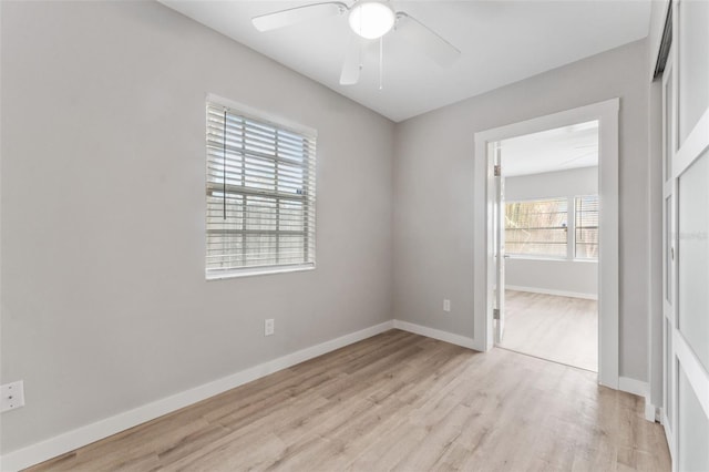 empty room with ceiling fan and light wood-type flooring