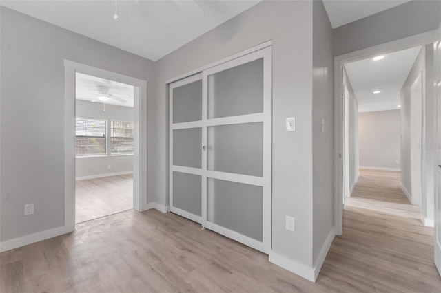 corridor with light hardwood / wood-style floors