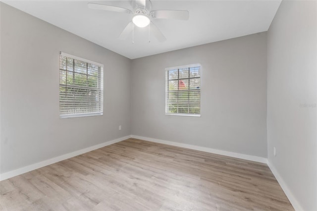 spare room with ceiling fan and light wood-type flooring