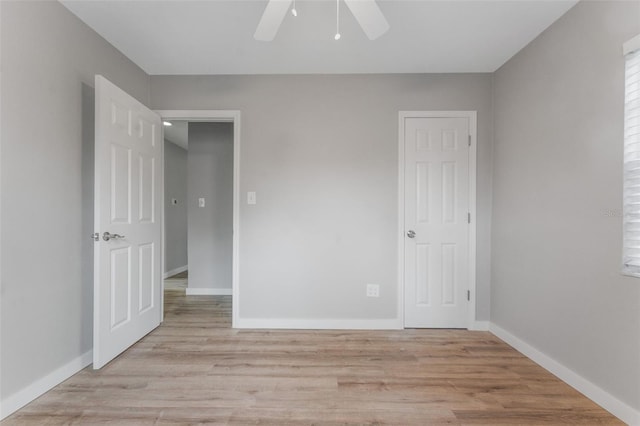 empty room with ceiling fan and light wood-type flooring