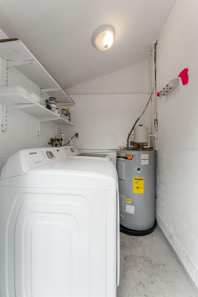 laundry room with water heater and washer / dryer