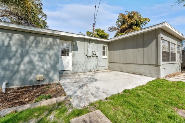 back of house featuring a patio and a yard