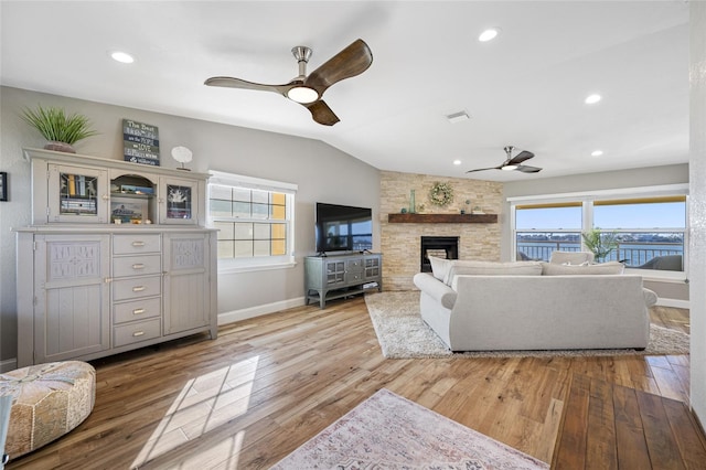 living room with lofted ceiling, plenty of natural light, light hardwood / wood-style floors, and ceiling fan