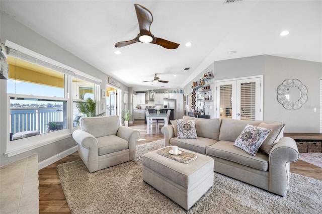 living room with hardwood / wood-style flooring, french doors, and ceiling fan