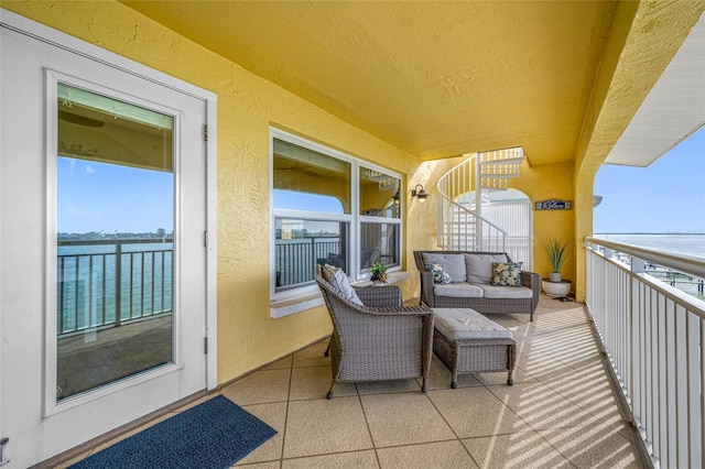 balcony with a water view and outdoor lounge area