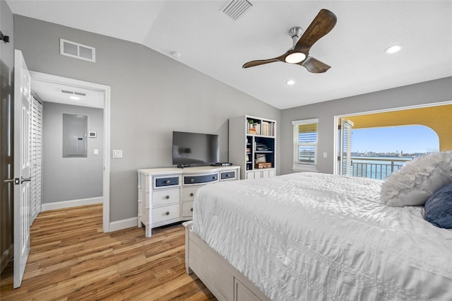 bedroom featuring lofted ceiling, light wood-type flooring, electric panel, ceiling fan, and access to exterior