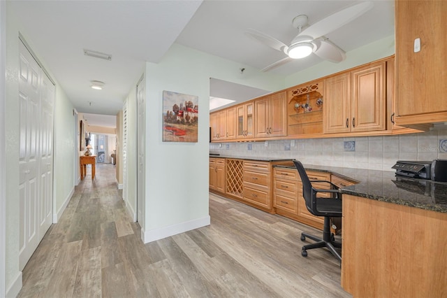 office space with light hardwood / wood-style flooring, built in desk, and ceiling fan