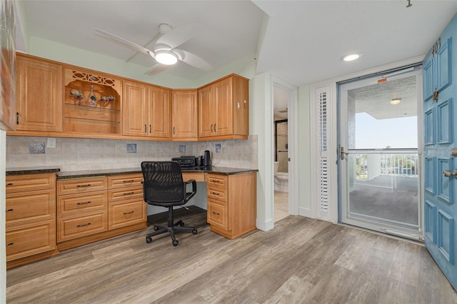 office area with ceiling fan, built in desk, and light hardwood / wood-style floors