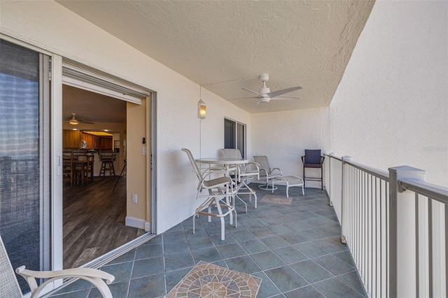 view of patio / terrace featuring ceiling fan and a balcony