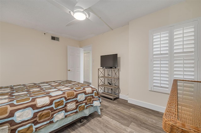 bedroom featuring wood-type flooring and ceiling fan