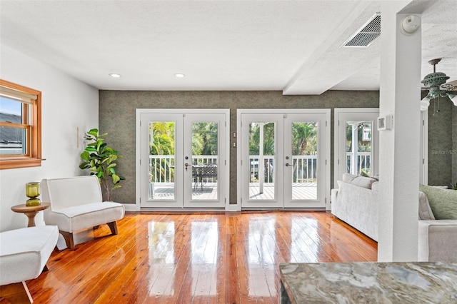 doorway featuring french doors, visible vents, and hardwood / wood-style floors