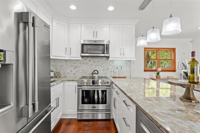 kitchen featuring light stone counters, white cabinets, appliances with stainless steel finishes, decorative backsplash, and dark wood finished floors