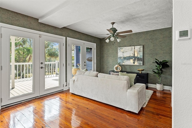 living room with a ceiling fan, french doors, baseboards, and hardwood / wood-style floors