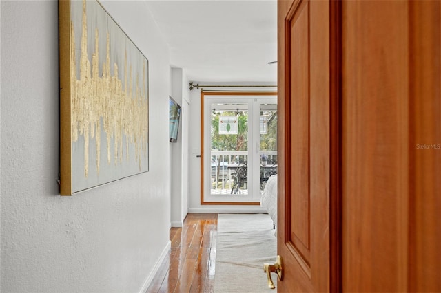 hallway featuring baseboards