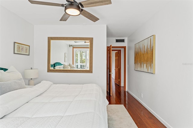 bedroom with visible vents, ceiling fan, baseboards, and wood finished floors