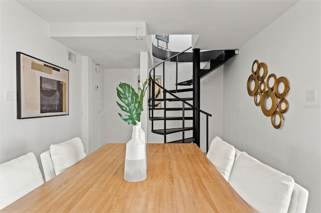 dining area featuring visible vents and stairway