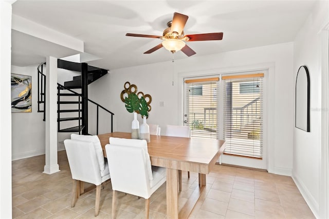 dining room with stairs, baseboards, a ceiling fan, and light tile patterned flooring