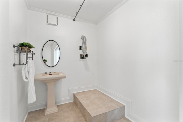 bathroom featuring baseboards, tile patterned floors, visible vents, and crown molding