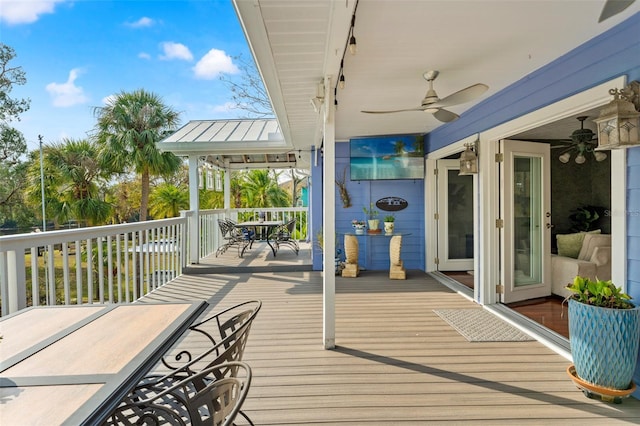 wooden deck with a ceiling fan and outdoor dining space