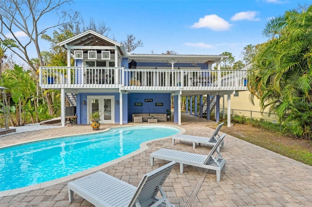 back of property with a patio area, stairs, and a wooden deck