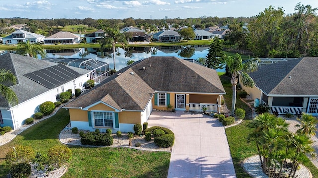 drone / aerial view with a water view and a residential view