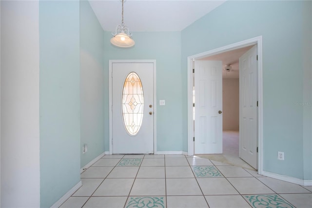 foyer entrance featuring light tile patterned floors and baseboards