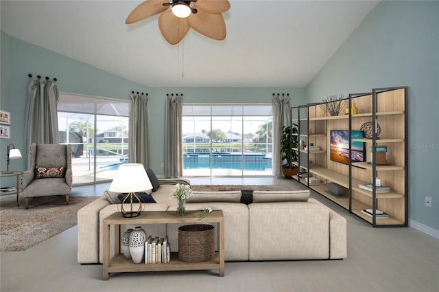 living room featuring a healthy amount of sunlight, vaulted ceiling, and ceiling fan