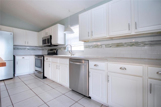 kitchen with white cabinets, light countertops, appliances with stainless steel finishes, hanging light fixtures, and decorative backsplash