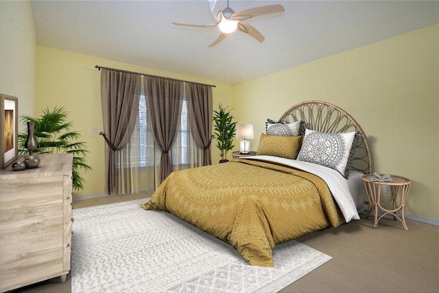 bedroom with ceiling fan and baseboards