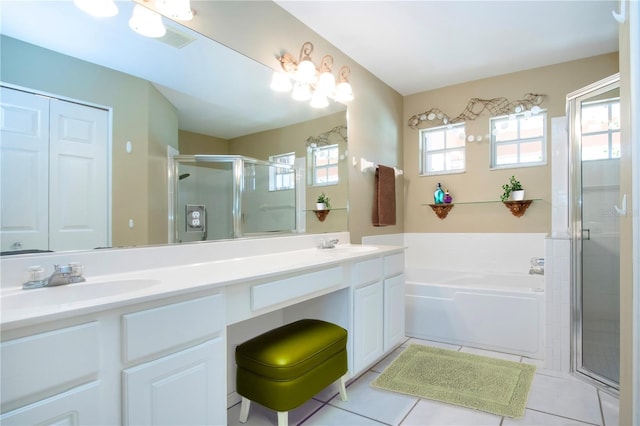 full bathroom with tile patterned floors, double vanity, a sink, and a bath