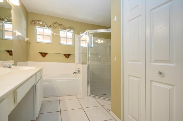 full bath featuring a stall shower, a garden tub, tile patterned flooring, vanity, and a closet