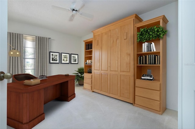 office area with a ceiling fan and light colored carpet