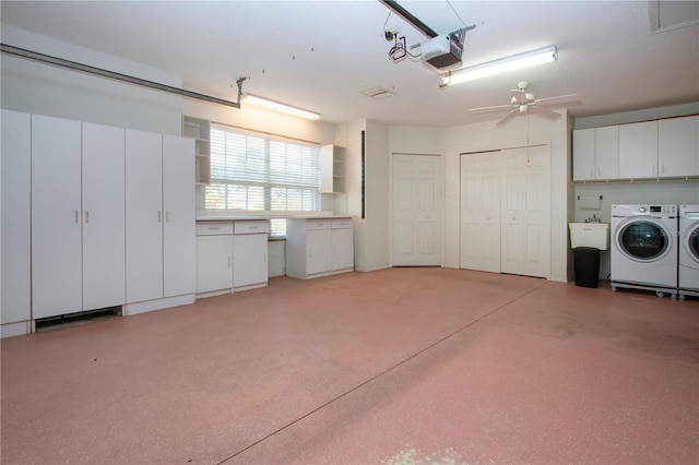 garage with separate washer and dryer, a sink, a ceiling fan, and a garage door opener