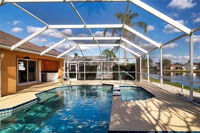 pool with a water view, glass enclosure, and a patio area