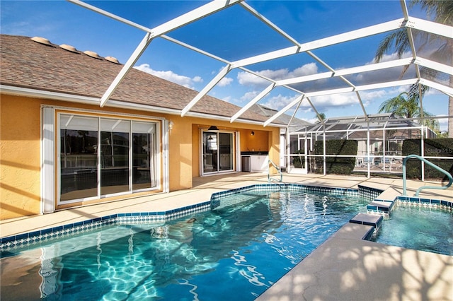 pool with glass enclosure and a patio