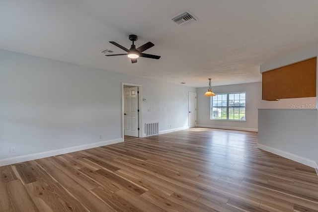 unfurnished room featuring hardwood / wood-style flooring and ceiling fan