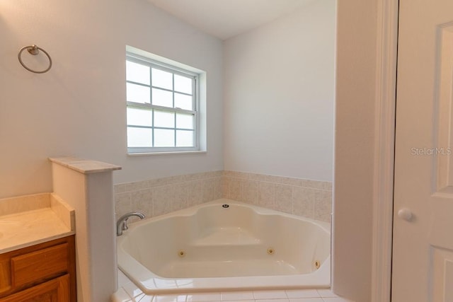 bathroom featuring vanity and tiled bath