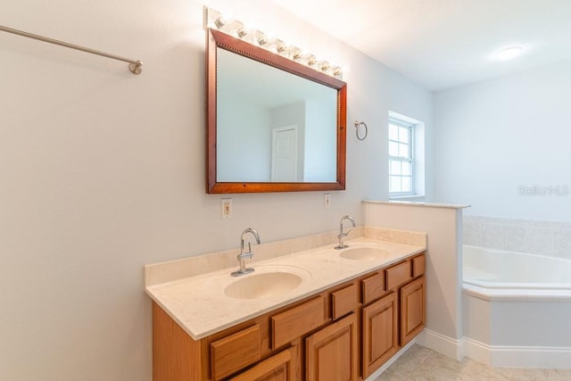 bathroom featuring vanity, a bath, and tile patterned flooring