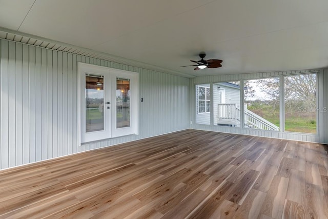 unfurnished sunroom with ceiling fan