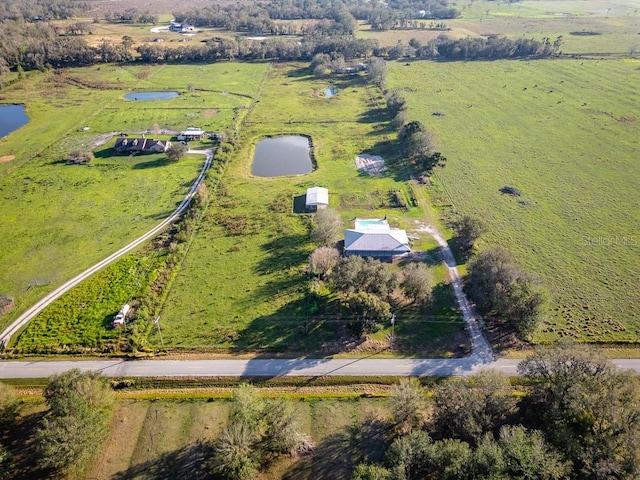 bird's eye view with a water view and a rural view