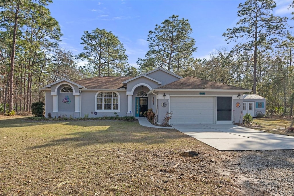 ranch-style home featuring a garage and a front yard