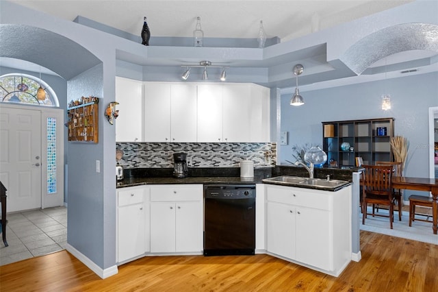 kitchen with sink, white cabinetry, hanging light fixtures, kitchen peninsula, and black dishwasher