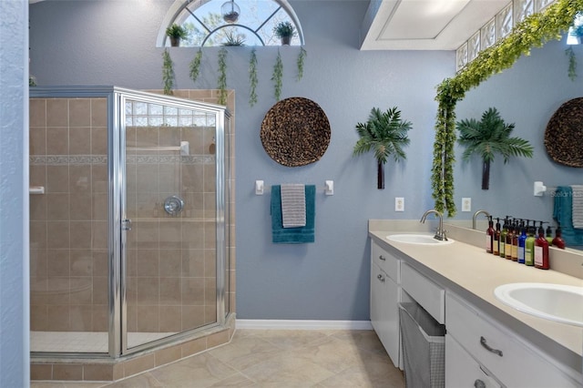 bathroom featuring vanity and a shower with door