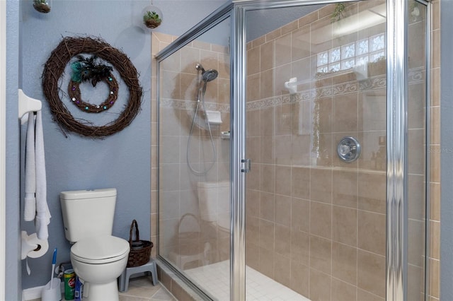 bathroom featuring toilet and walk in shower