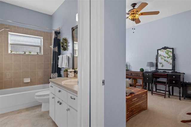 full bathroom with shower / tub combo with curtain, tile patterned floors, toilet, vanity, and ceiling fan