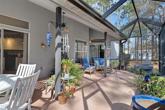 view of patio with an outdoor living space and a lanai