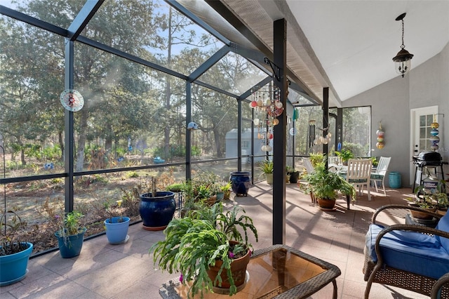 view of patio / terrace featuring glass enclosure and a storage shed