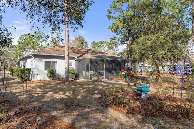 back of property featuring a lanai