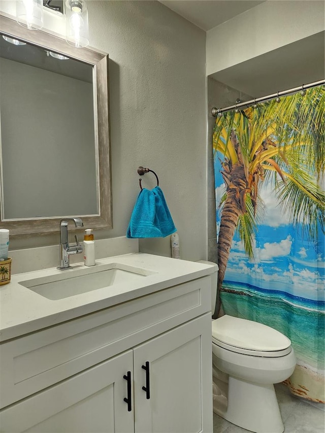 bathroom featuring vanity and toilet