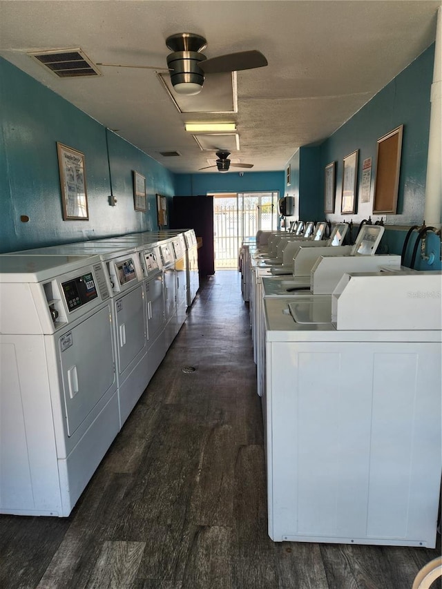 laundry area with washing machine and dryer and dark hardwood / wood-style flooring